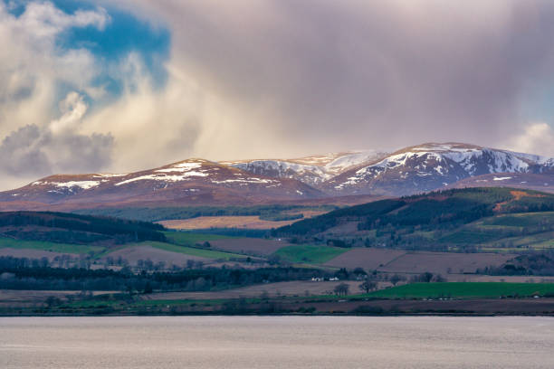 Ben Wyvis is a mountain located in Easter Ross, Sottish Highlands, UK.   It is north-west of the town of Dingwall.  The summit of Ben Wyvis is 3432 ft, making it a ‘Munro’.   Ben Wyvis is a Gaelic name which translates into English as “the hill of terror”.  In the foreground the Cromarty Firth.  A snow storm is approaching.
