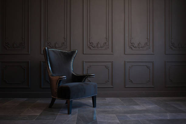 istock Stylish black chair against a dark gray wall 1156102130