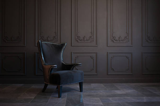 Stylish black chair against a dark gray wall stock photo