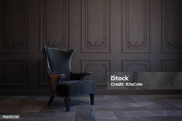 Stylish Black Chair Against A Dark Gray Wall Stock Photo - Download Image Now - Chair, Retro Style, Domestic Room