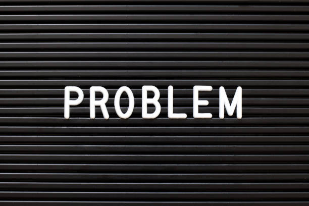 istock Black color felt letter board with white alphabet in word problem background 1156103140