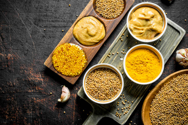 istock Mustard in a plate, on a cutting Board and a stand. 1156103231