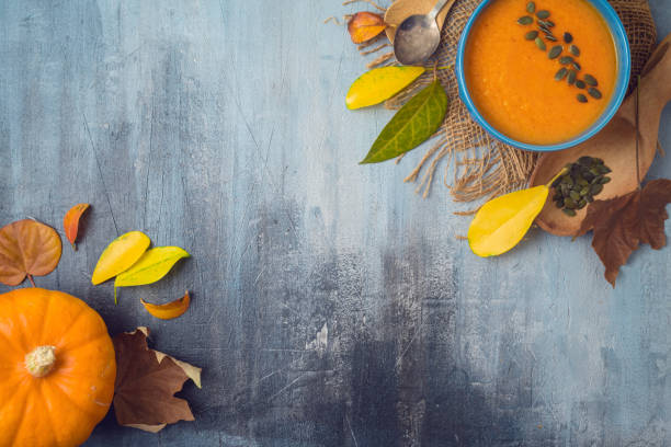 istock Pumpkin soup on rustic background. Autumn concept with pumpkin and fall leaves. 1156103654