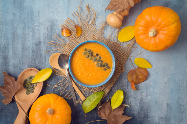 istock Pumpkin soup on rustic background. Autumn concept with pumpkin and fall leaves. 1156103660