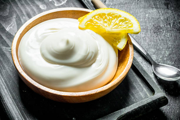 istock Mayonnaise on a cutting Board with lemon slices. 1156104555