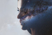 The universe inside us, the profile of a young woman and space, the effect of double exposure.