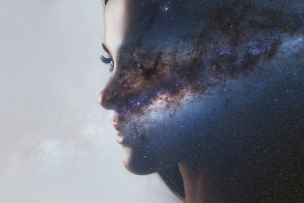 The universe inside us, the profile of a young woman and space, the effect of double exposure. stock photo