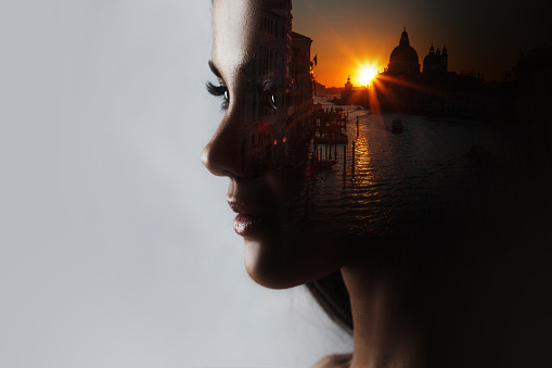 Travel dreams, concept. The profile of the girl and the sunset in a beautiful location, double exposure