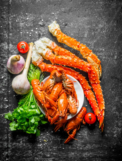 istock Seafood. Cooked crayfish and crab with garlic, parsley and tomatoes. 1156105597
