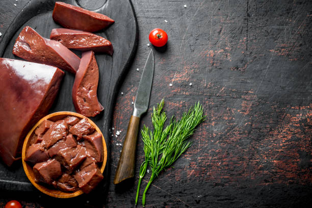 istock Pieces of raw liver on a cutting Board with dill. 1156106643