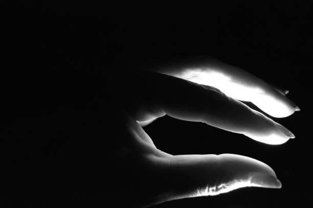 istock human hand illuminated in the dark 1156107882