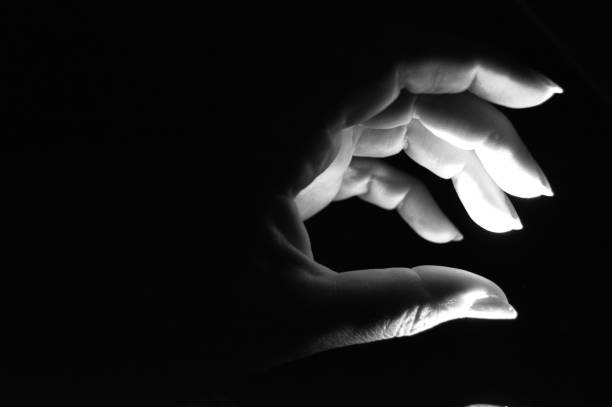 istock human hand illuminated in the dark 1156108015