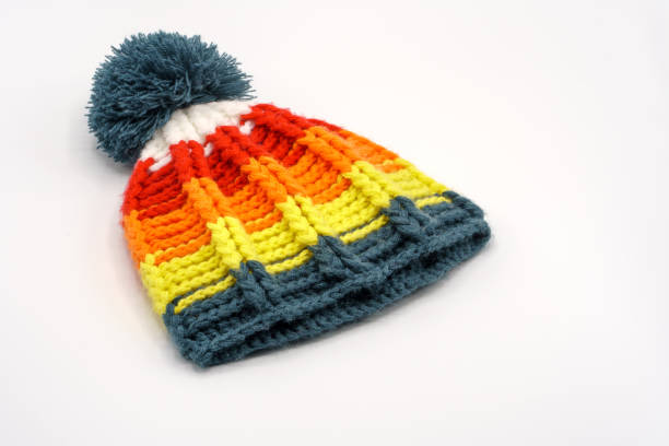 Colorful winter knitted hat on a white background. Handwork. Winter fashion concept for men, women and children.