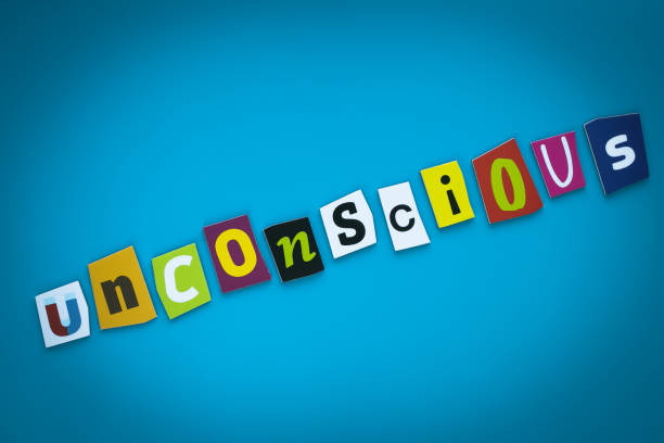 istock A single word - Unconscious - from cut colorful letters on a blue background. Text on banner. Inscription on card. Psychologic concept. Caption, heading, multicolored headline. Message on poster. 1156108306