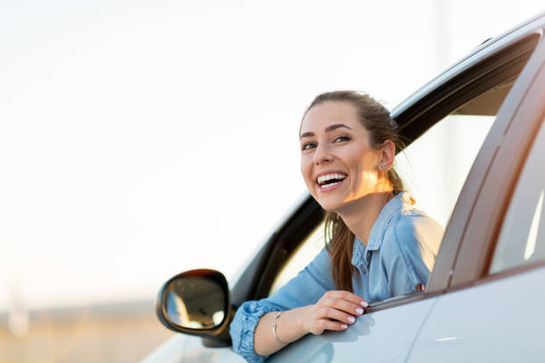 istock Woman driving car in the sunset 1156109718