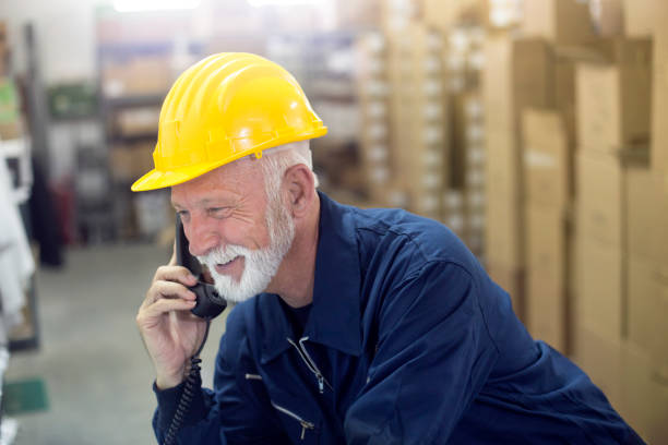istock Warehouse worker talking on landline phone 1156110488