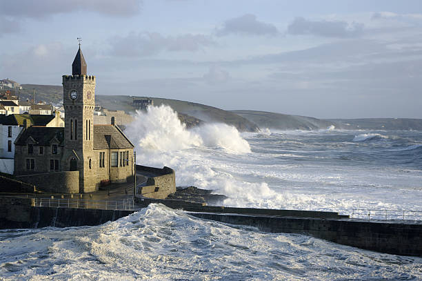 A stormy sea with big waves hitting the outer harbour at Porthleven Cornwall UK. Late afternoon after high tide on the 14th November 2009.