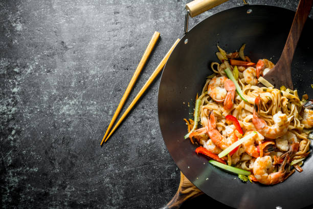 istock Chinese wok. Delicious Udon noodles with chopsticks. 1156112968