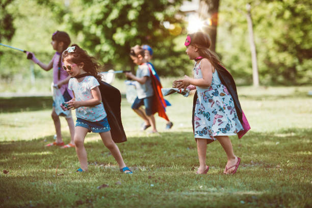 istock Educator and kids cleaning garbage from a park 1156114133