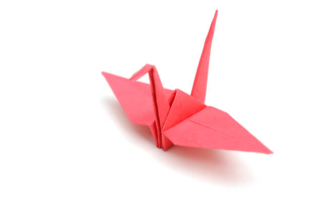 istock Red origami bird isolated on white 1156119870