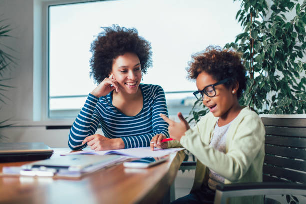 istock Mother and daughter doing homework learning to calculate 1156120748