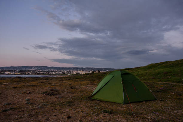 istock Green tent standing on the hill in spring 1156120809