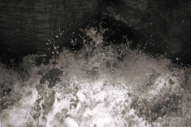 Water splash in black and white. Darkness ans shadow. Water in dynamic motion. Monochrome abstract background. Dynamism and energy concept.