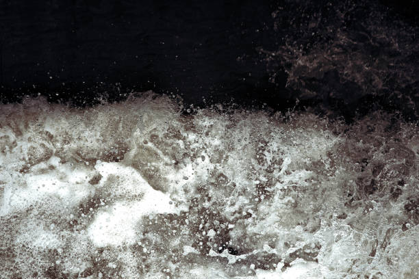 istock Water splash in black and white. Darkness and shadow. Water in dynamic motion. Monochrome abstract background. 1156121862