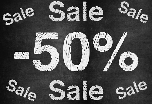 50 percent discount. Blackboard with text '50%'.