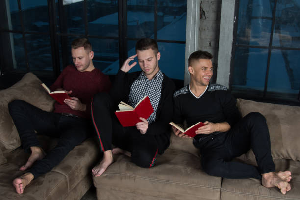 istock Friends at home reading books. 1156129148