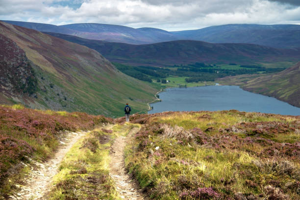 Hiking trail in Cairngorm Mountains. Angus, Scotland, UK Tourist walking down from Cairn Lick to Loch Lee. Cairngorms National Park, Angus, Scotland, UK cairngorm mountains stock pictures, royalty-free photos & images