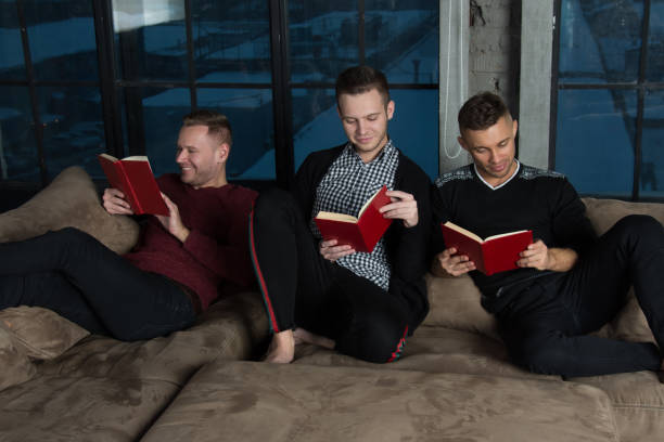 istock Friends at home reading books. 1156129869