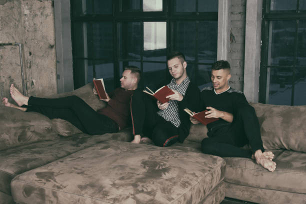 istock Friends at home reading books. 1156129937