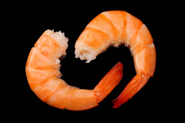 istock shrimps isolated on a black background. top view 1156131123
