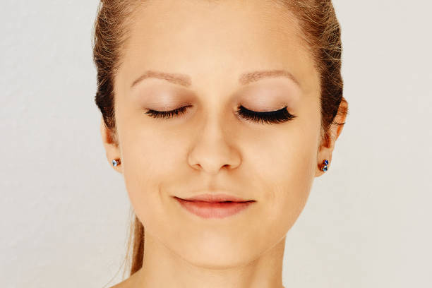 istock Female face with closed eyes with long false eyelashes, befor and after change 1156132224