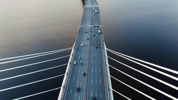 istock flycam shows cable-stayed bridge pylons with cars downwards 1156132396