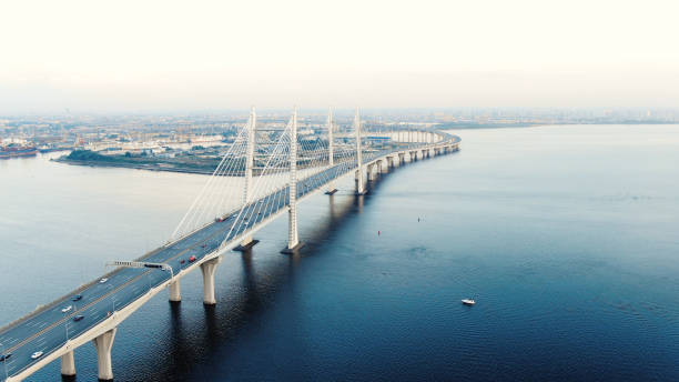 istock flycam moves above long cable-stayed bridge with pylons 1156132420