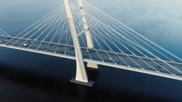 istock flycam shows modern cable-stayed bridge with pylons and cars 1156132466
