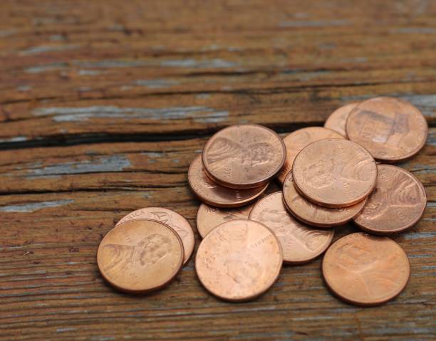 istock Stack of coins on wooden background 1156134628