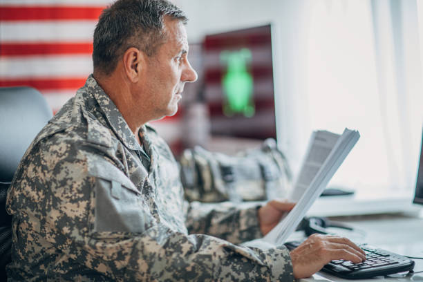 istock Senior man in US military holding documents 1156139391