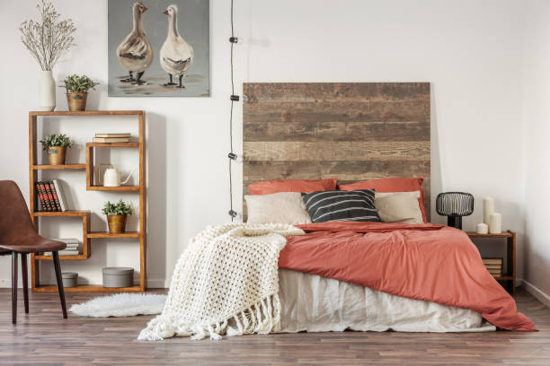 istock Beautiful bedroom interior with king size bed wooden headboard 1156140412