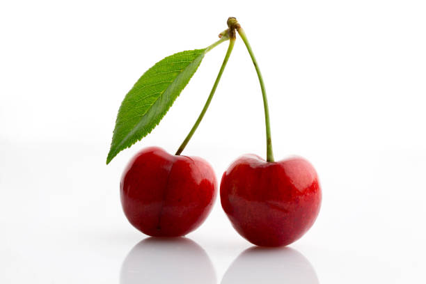istock Fresh and ripe sweet cherry with green leaf close up 1156142561