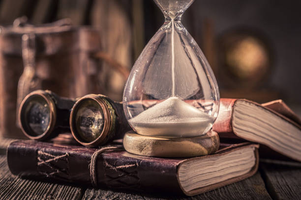 istock Journal and hourglass as a concept of journey diary 1156142600