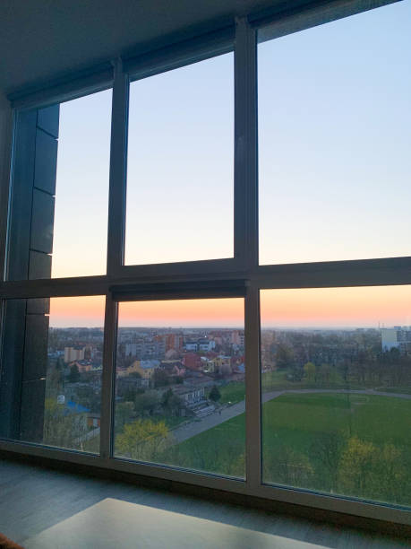 istock Panoramic windows overlooking beautiful golden sunset. View from home window 1156142693