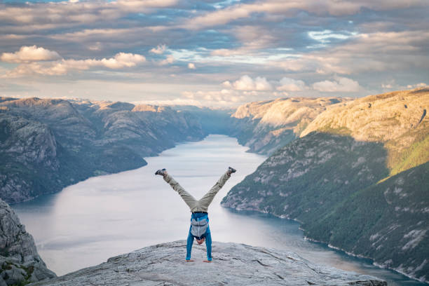 Handstand, Pulpit Rock Preikestolen, Norway Athletic man pressing a handstand on top of the famous Preikestolen Pulpit Rock, Norway. Nikon D850. Converted from RAW. ryfylke stock pictures, royalty-free photos & images