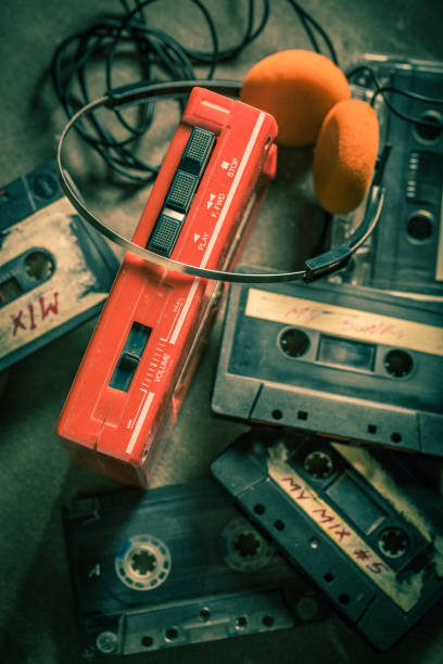 istock Old cassette tape with walkman and headphones on grey table 1156144671