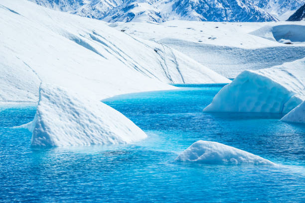 istock Large icebergs in blue pool on the Matanuska Glacier. 1156144736