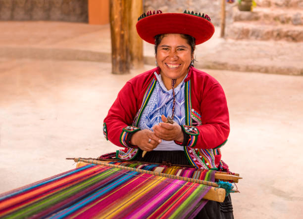 the ancient Andean tradition way of making textiles Cuzco, Peru - April 30, 2019. Peruvian woman working on traditional handmade wool production bolivian andes photos stock pictures, royalty-free photos & images