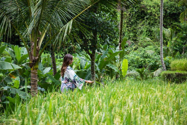 istock Beautiful woman on green rice fields in Bali with copy space 1156145547