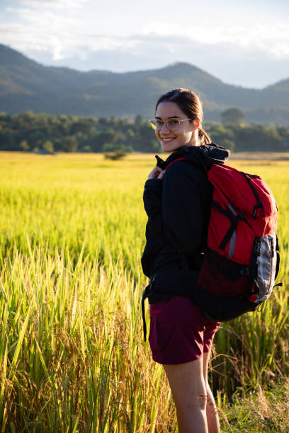 istock Beautiful traveler woman with backpack on rice fields in Thailand with copy space 1156145569